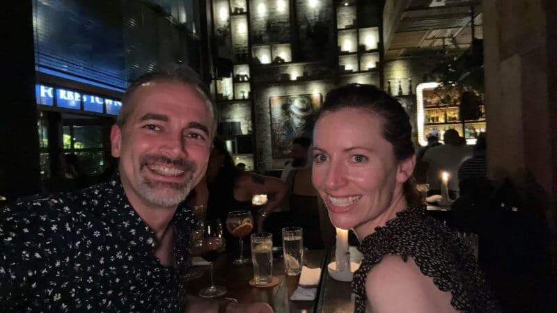 Isaac and Meryl taking a selfie at a candlelit bar table
